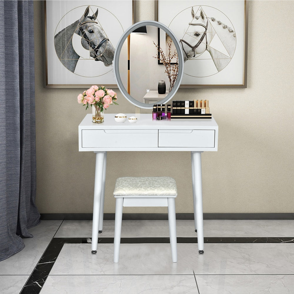 White dressing table with illuminated mirror and stool in a bedroom setting