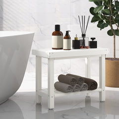 The shower stool placed in a modern bathroom next to a white bathtub with toiletries and towels
