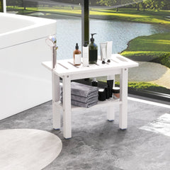 The bath stool positioned by a large window with towels and bottles on the lower shelf