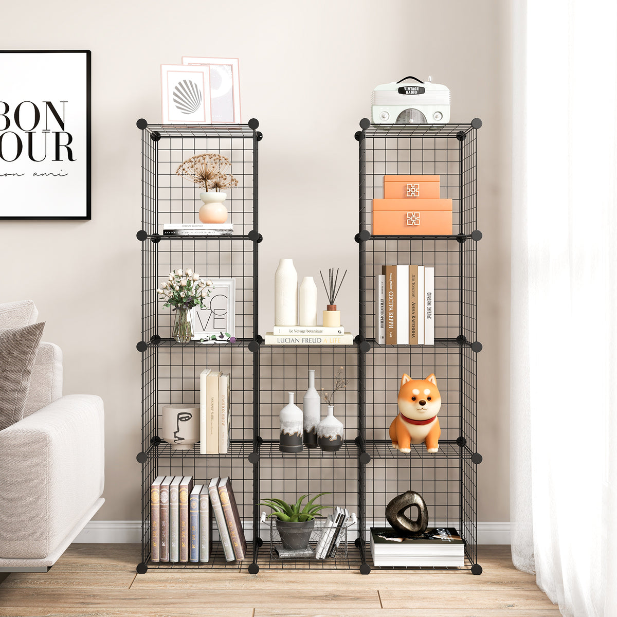 The black wire cube storage unit arranged in two sections with books and decorative items