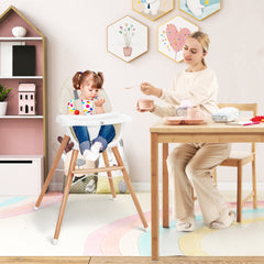 The high chair in a child's bedroom with a toddler eating while a woman feeds them