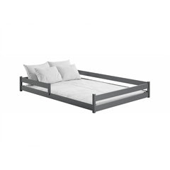 The dark grey wooden bed frame with white bedding and pillows