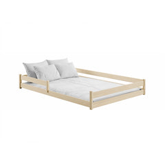The natural pine wooden bed frame with white bedding and pillows