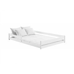 The white wooden bed frame with white bedding and pillows