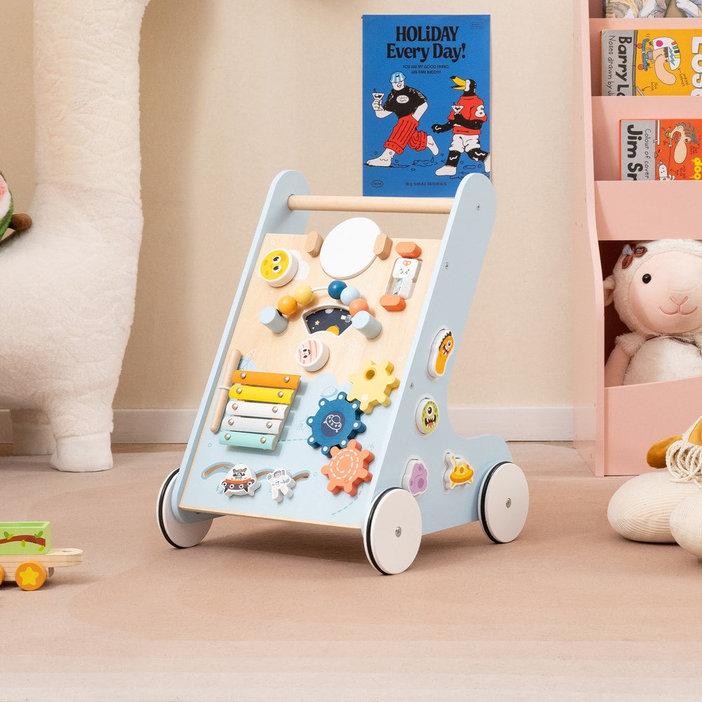 The blue baby walker with activity board in a nursery room