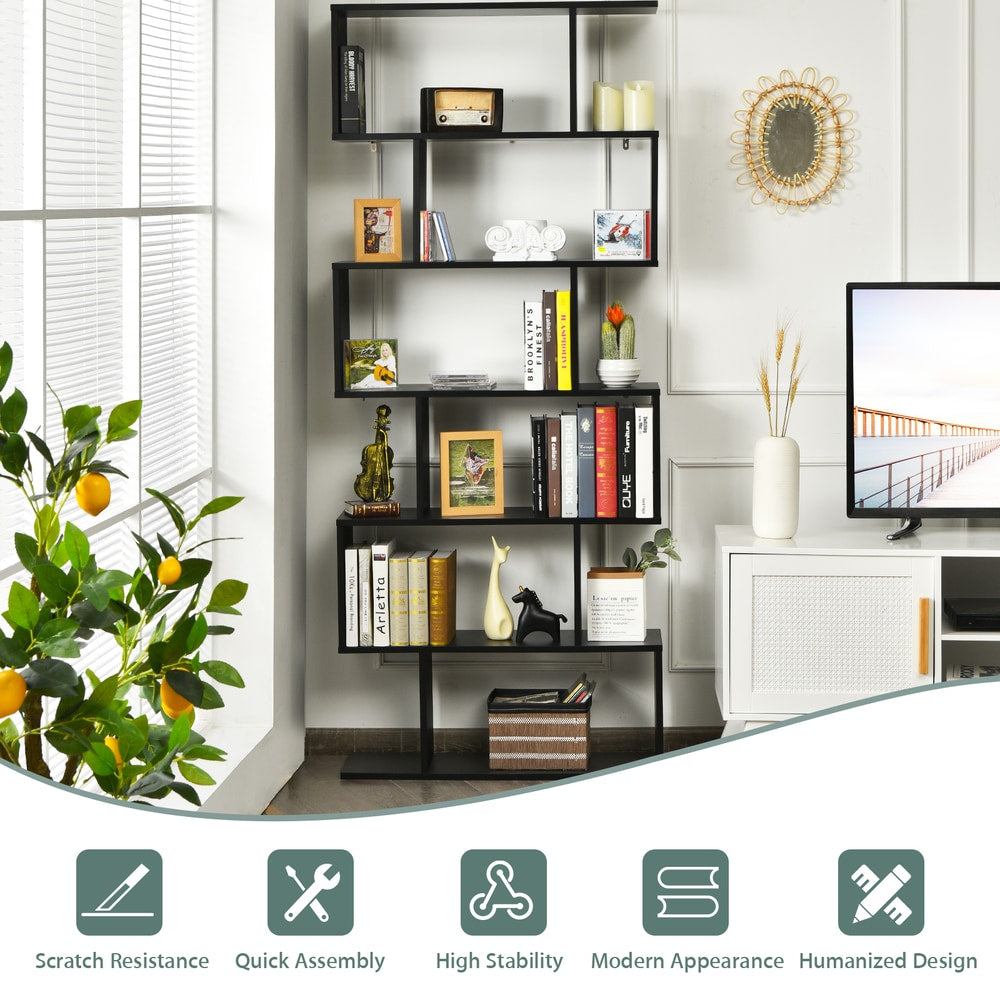 Close up of the black S-shaped bookcase showing its construction and some decorative items