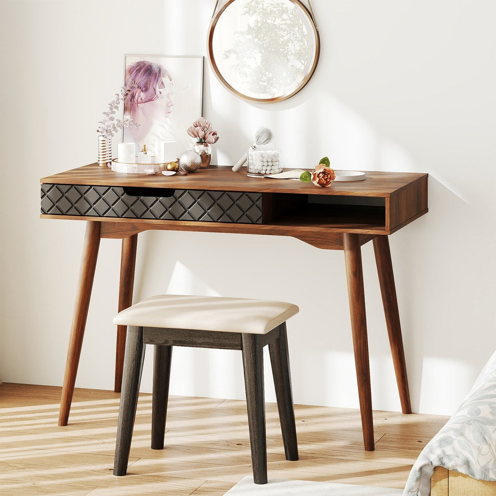 The office desk is shown in a bedroom setting with a stool and mirror