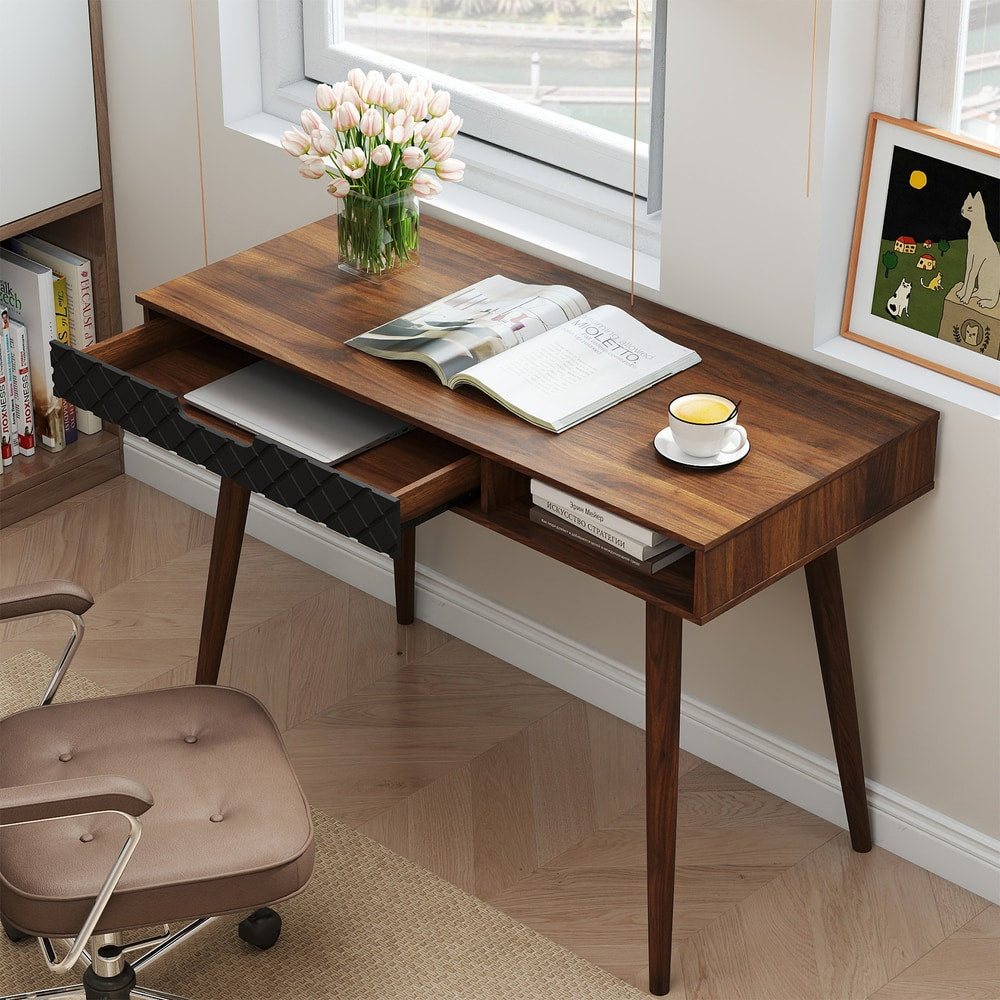 This office desk has its drawer pulled out, revealing storage space for a laptop