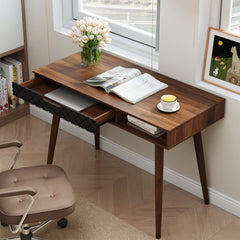 This office desk has its drawer pulled out, revealing storage space for a laptop