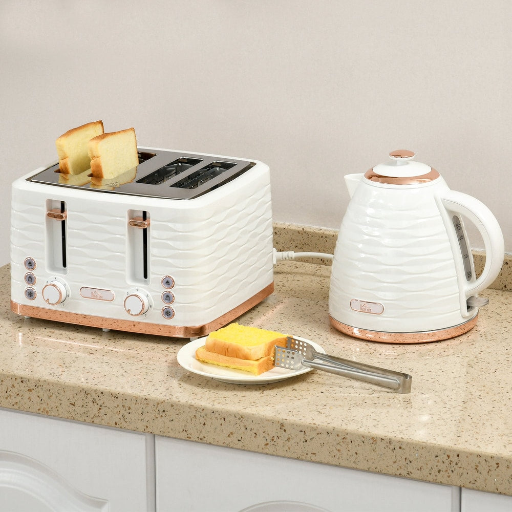 The four-slice toaster with bread slices inside sitting on a kitchen counter next to a kettle
