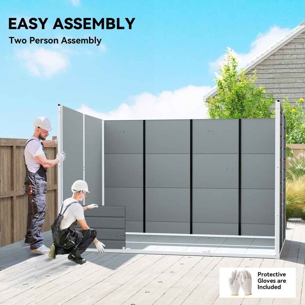 Two people assembling the grey garden shed, showing the construction process
