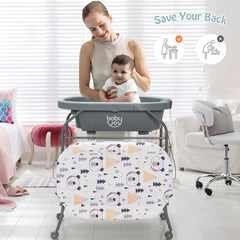 The changing table in use with a mother holding her baby in the bath section in a bright room