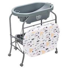 The changing table with the patterned changing mat folded down to reveal the grey bath tub