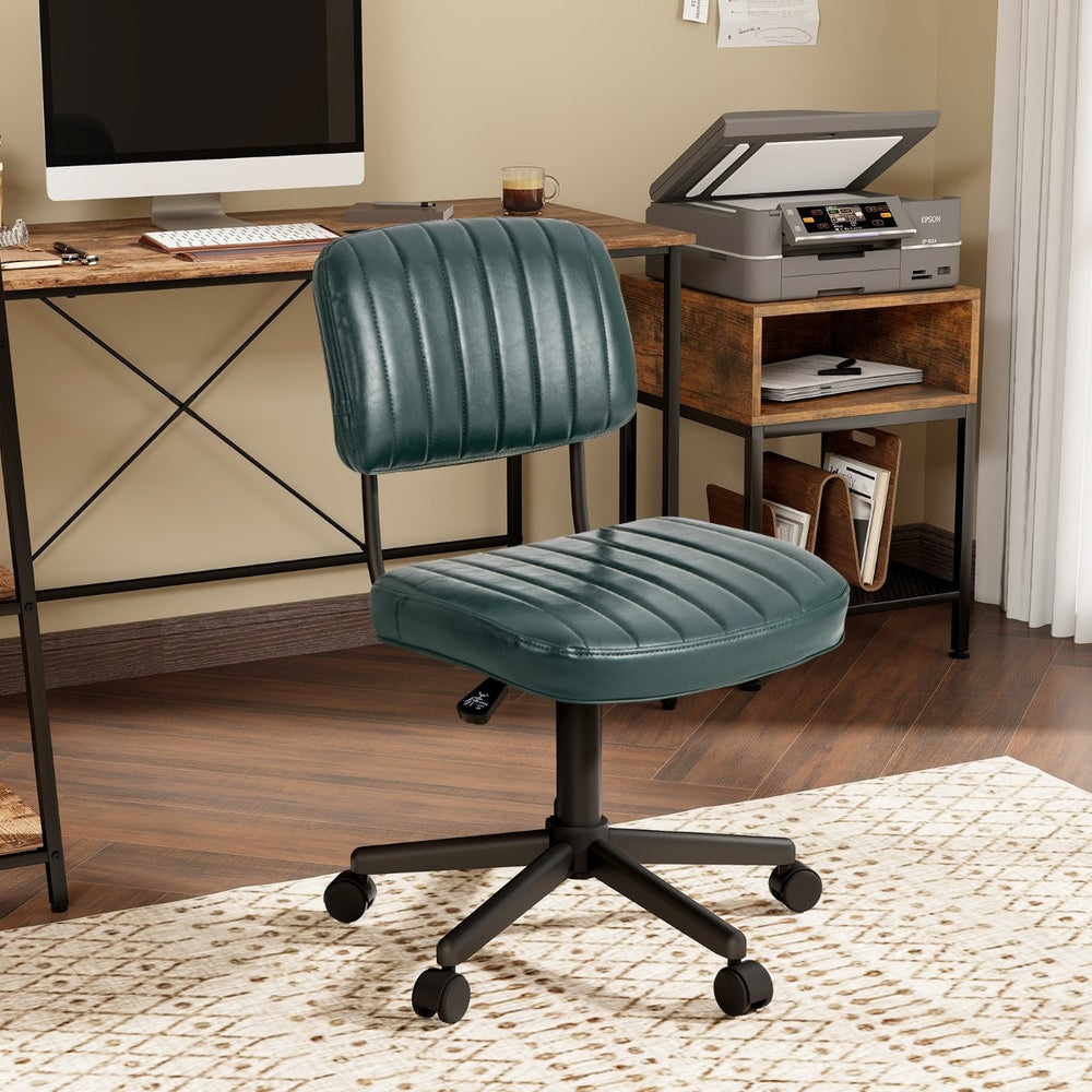 The green office chair is placed beside a desk with a computer monitor