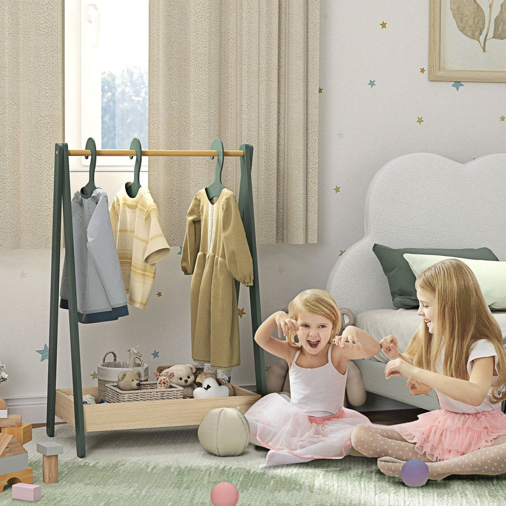 The green kids clothes rail in a nursery with two young girls playing around it