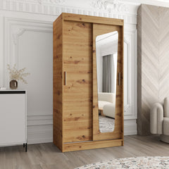 The wood effect sliding door wardrobe with a single shaped mirror panel in a living room