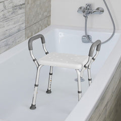 The grey shower stool placed inside a bathtub for use