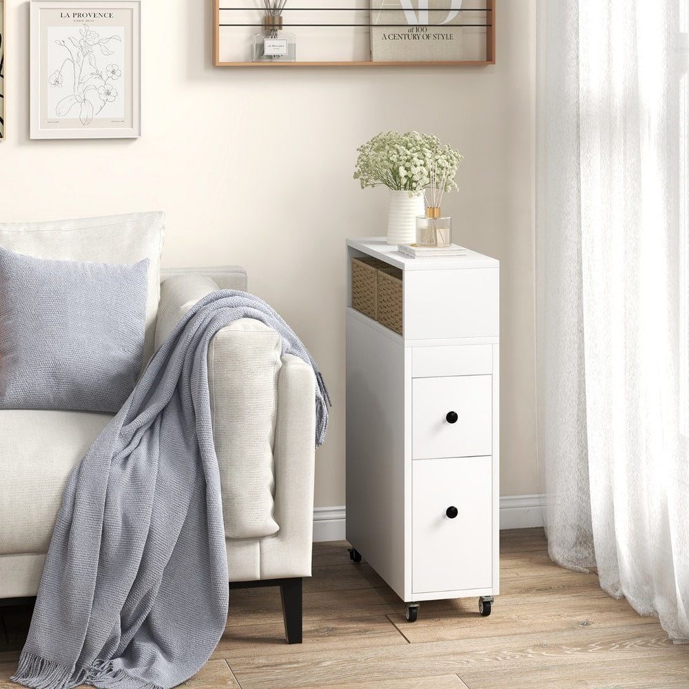 White slim bathroom storage cabinet in a living room next to a sofa