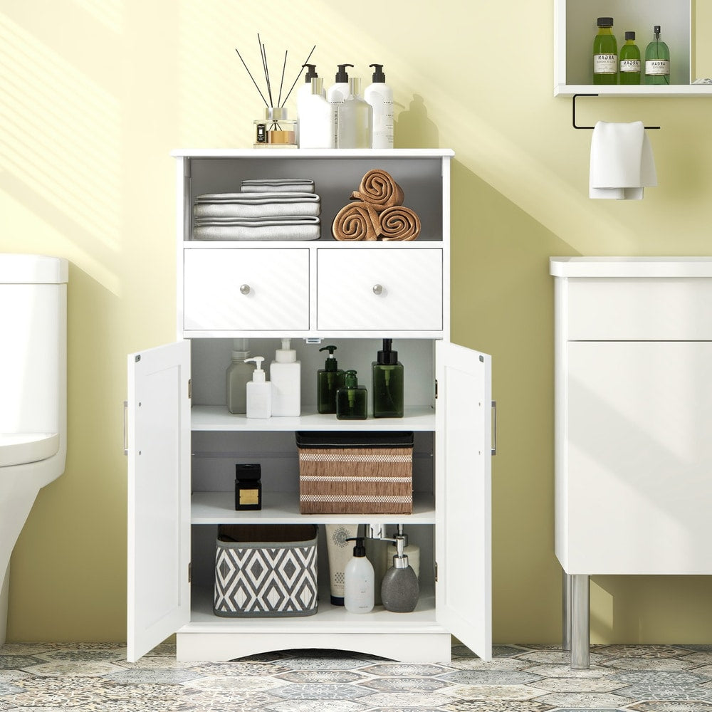 White floor cabinet in a bathroom, filled with various bathroom items