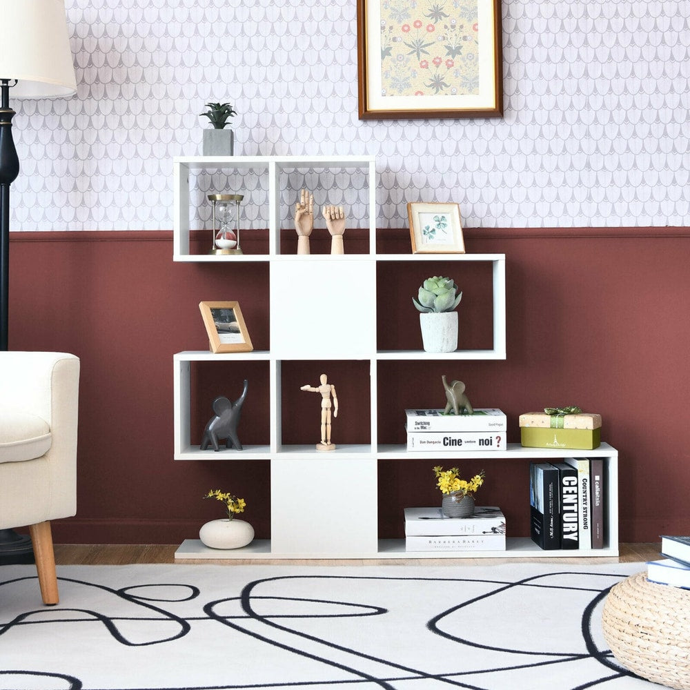 The white display and storage bookshelf with a stepped design, styled with ornaments