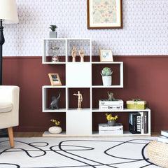 The white display and storage bookshelf with a stepped design, styled with ornaments