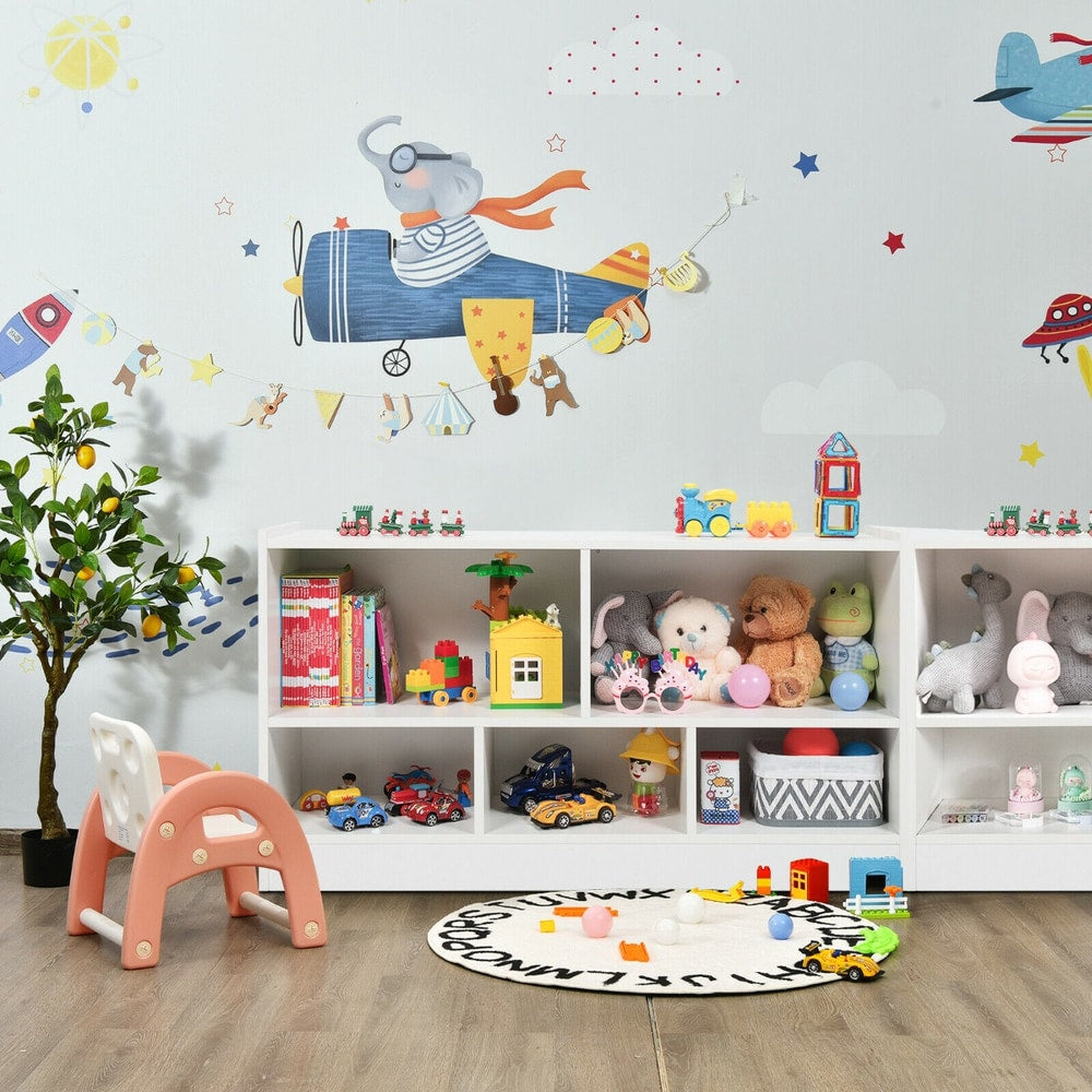 Kids storage bookcase filled with toys and books in a child's playroom with wall decals