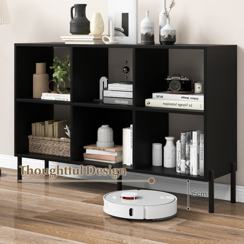 The black open bookshelf with a robot vacuum cleaner underneath