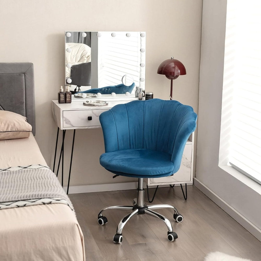 The blue office chair placed next to a bed and dressing table in a bedroom setting