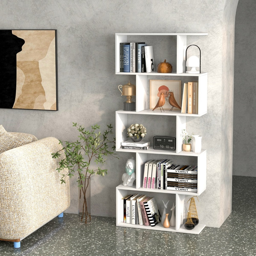 The white shelving unit in a modern home office, filled with books and decor