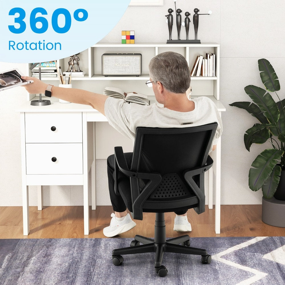 Person sitting in the black office chair at a desk to demonstrate the swivel movement