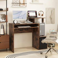 The office desk set up in a home study with a computer, laptop and office chair