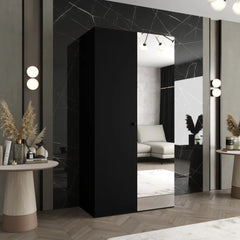 The hinged wardrobe in a black finish with a mirrored door