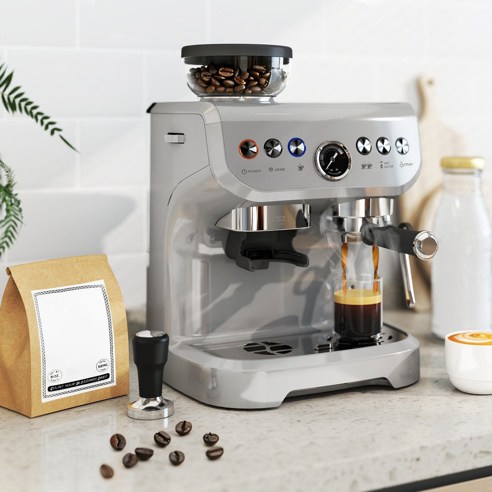 The coffee machine on a kitchen counter with a bag of coffee beans and a tamper