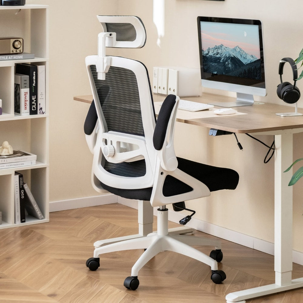 The office chair placed at a wooden desk with a computer monitor