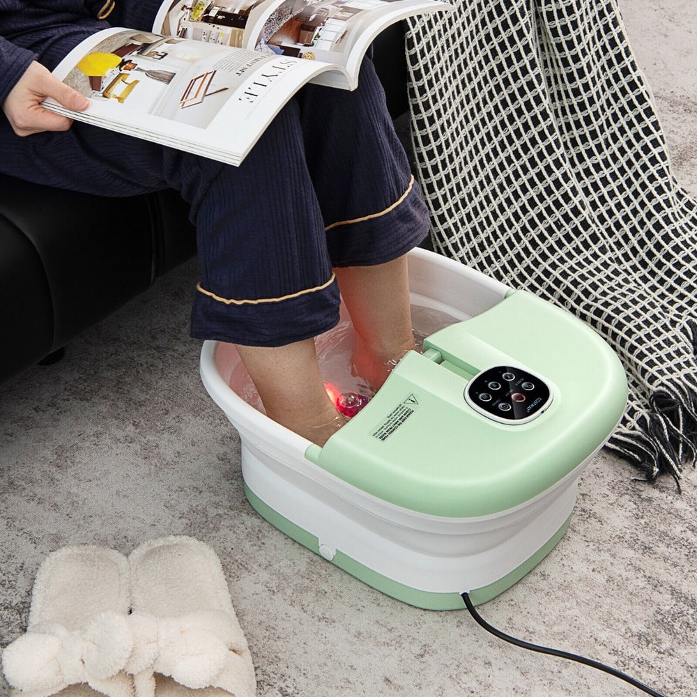 Person using the green foot spa bath massager with bubbles and heat