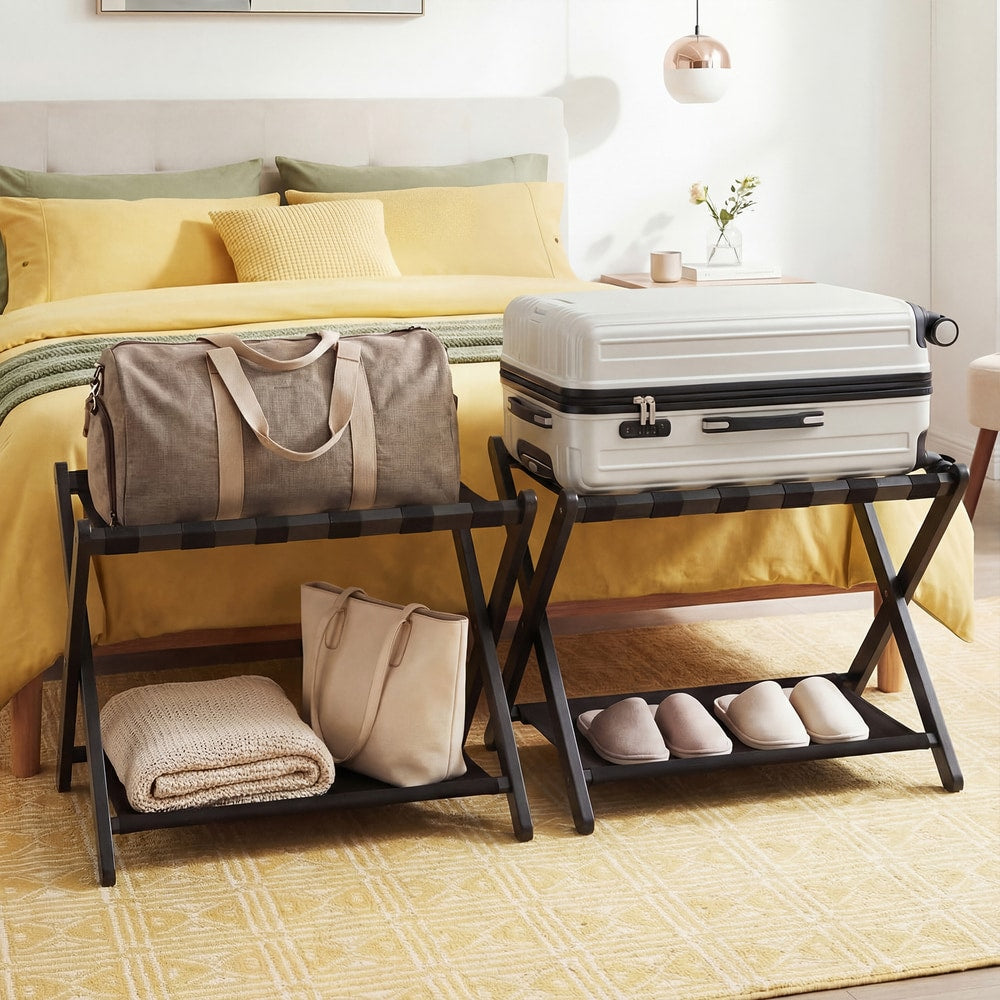 Two black folding luggage racks in a bedroom, one holding a suitcase and bag, the other a suitcase and folded blankets
