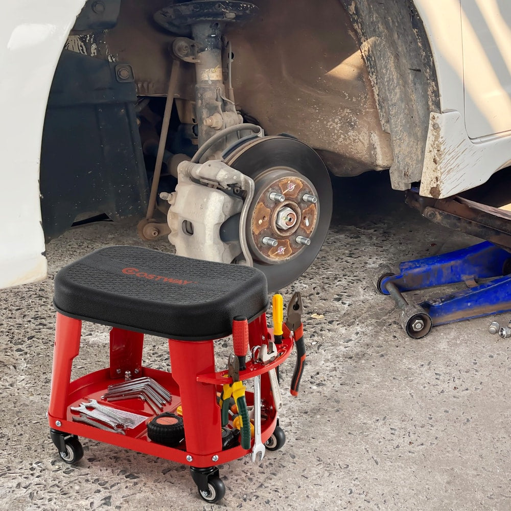 The red garage stool with equipment tray and tool holder shown next to a car wheel and suspension