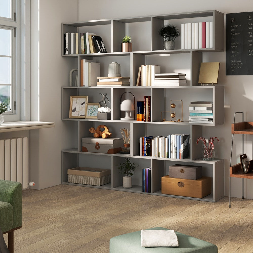 The grey shelving unit placed in a room with a wooden floor and home decor