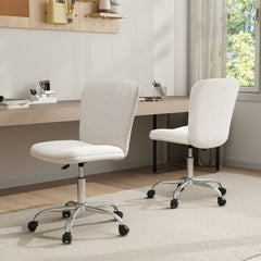 Two white office chairs with wheels positioned at a desk in a home office setting