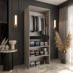 The hinged wardrobe interior with hanging clothes and folded items