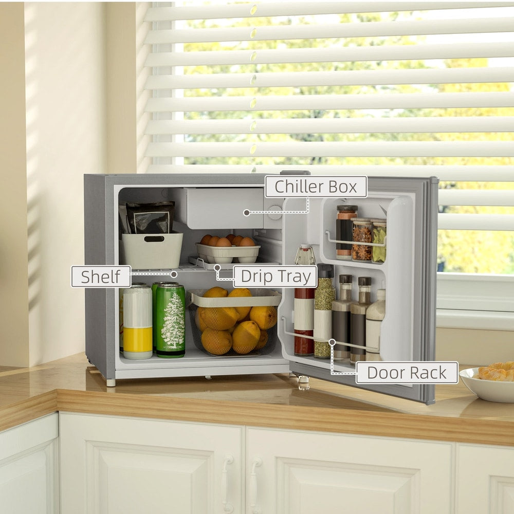 The grey countertop fridge with the door open, showing a shelf, drip tray and door rack