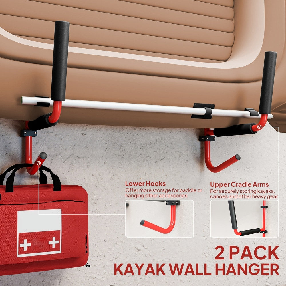 Two red kayak wall hangers with black padded arms, one holding a medical kit and a bag