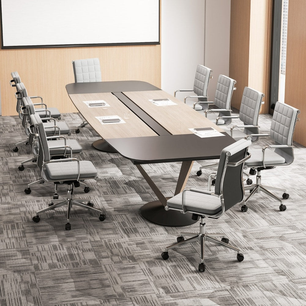 Multiple office chairs arranged around a large meeting table in a conference room