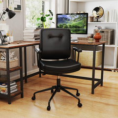 The office chair positioned in a home workspace with a wooden desk and shelves in the background