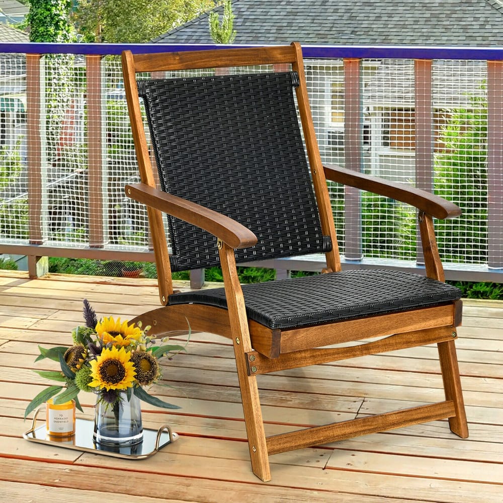 The outdoor chaise lounge is set up on a wooden deck next to a vase of sunflowers