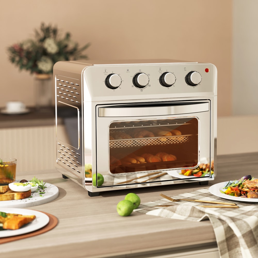 the air fryer oven on a kitchen counter, with food items like toast, chicken wings, and pizza displayed around it