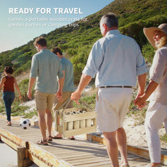 Family carrying the wooden scatter game set in a wooden box to a beach
