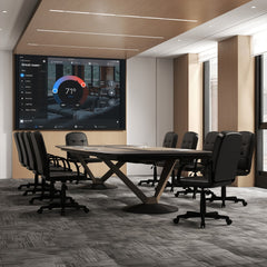 Several office chairs around a large conference table in a modern meeting room