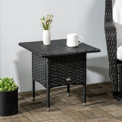 the rattan side table on a patio with a plant and a mug on top
