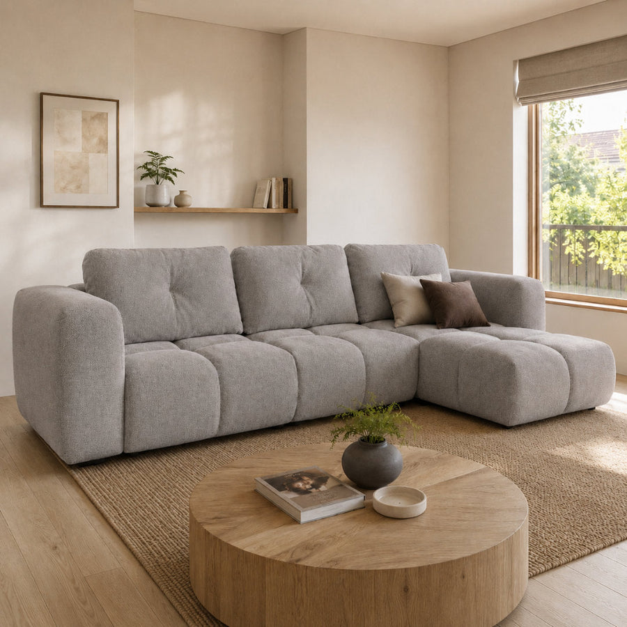 Corner Sofa Bed Modi III in light grey fabric, shown in a living room setting